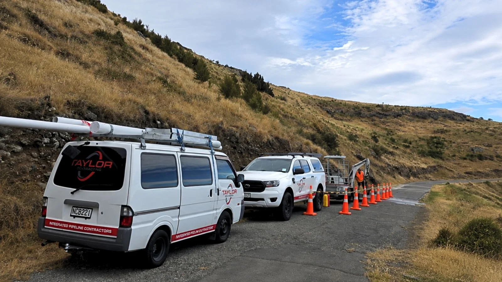 Taylor Plumbing van, ute and mini excavator on a Whangarei job site